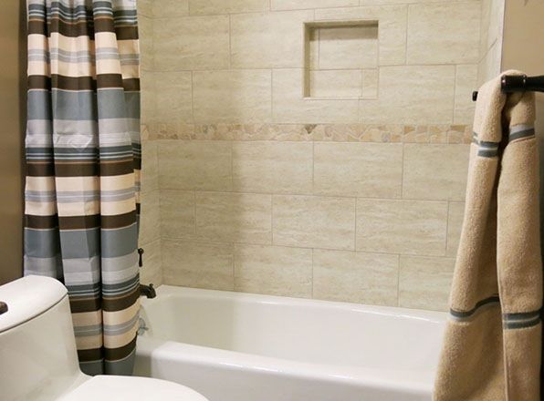Bathtub with tile design with inset shelf. Bathroom Remodeling. Johnson County Remodeling.