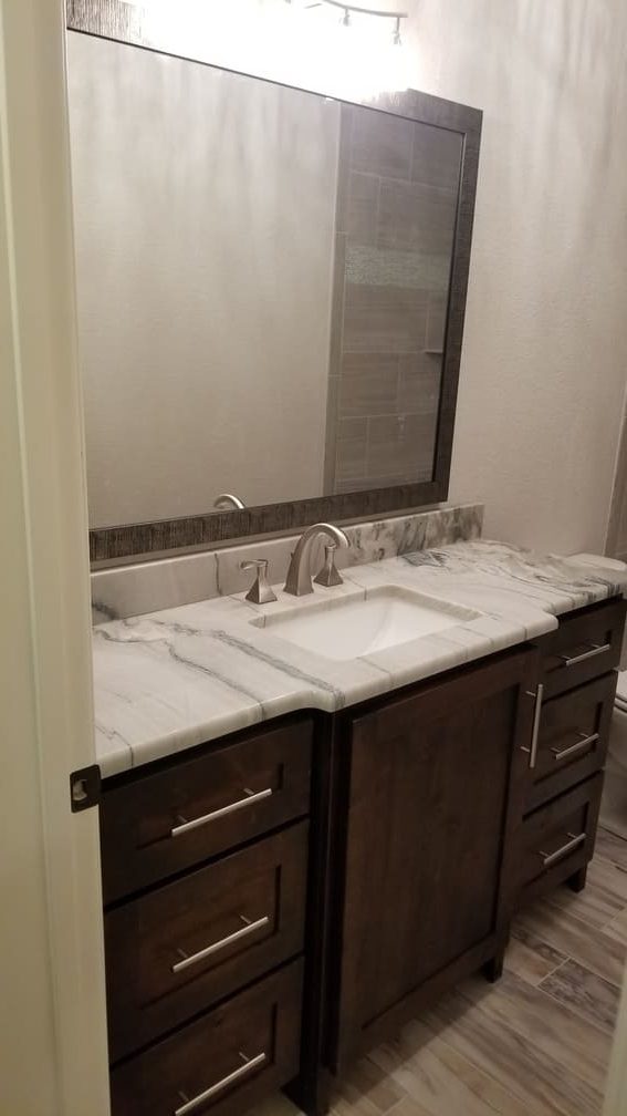 Mirror above sink with marble counter top. Bathroom Remodeling. Johnson County Remodeling.